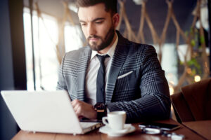 Busy executive working on the laptop in a cafe
